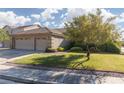 Charming single Gathering home with a three-car garage, mature landscaping, and a well-maintained lawn at 240 Jumping Springs Pl, Henderson, NV 89012