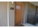 Close-up of unit 1733 front door with black hardware and neutral color at 2900 Sunridge Heights Pkwy # 1733, Henderson, NV 89052