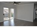 Spacious living room featuring wood-look floors, ceiling fan, and balcony access at 2900 Sunridge Heights Pkwy # 1733, Henderson, NV 89052