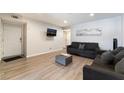 Cozy living room with hardwood floors, comfortable couches, and a view of the entrance at 3120 S Eastern Ave # 6, Las Vegas, NV 89169