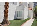 Charming exterior view highlighting the manicured grass and beautiful desert landscaping at 3132 Centavo Dr, Las Vegas, NV 89117