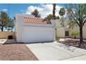Charming two-story home featuring a large two-car garage and desert landscaping at 3132 Centavo Dr, Las Vegas, NV 89117