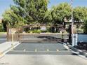 Community gate with iron bars and mature landscaping to keep the property secure at 4567 Madreperla St, Las Vegas, NV 89121