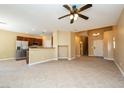 Bright, open-concept living room, adjacent kitchen with stainless appliances and tile floors at 5676 Bettors Luck Ct, Las Vegas, NV 89122