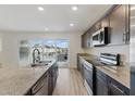 Close-up of the contemporary kitchen showcasing granite countertops, stainless steel appliances, and sleek cabinetry at 6850 Magenta Moon St, North Las Vegas, NV 89086