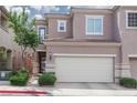 Inviting home with a two-car garage, desert landscaping, and a covered porch, providing great curb appeal at 689 Principle Point Ave, Henderson, NV 89012