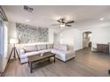 Spacious living room with wood-look floors, neutral tones, and comfortable seating, perfect for relaxation at 7732 Canon Walk St, Las Vegas, NV 89139