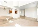 Open-concept living room, showcasing high ceilings, tile flooring, and modern chandelier at 7941 Limestone Arch Ave, Las Vegas, NV 89178