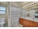 Bright bathroom featuring double sinks, and a shower-tub combination at 8421 Cheerful Brook Ave, Las Vegas, NV 89143