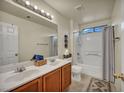 Bright bathroom featuring double sinks, and a shower-tub combination at 8421 Cheerful Brook Ave, Las Vegas, NV 89143