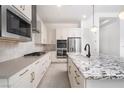 Stylish kitchen features an island, modern appliances, and ample cabinet space at 91 Alta Cascata Pl, Henderson, NV 89011