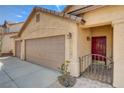 Warm-toned single-Gathering home with a three-car garage, desert landscaping, and gated front porch at 9530 Redstar St, Las Vegas, NV 89123