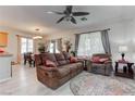 Inviting living room with plush seating, neutral tones, abundant natural light, and dining area at 9844 Red Horse St, Las Vegas, NV 89143