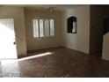 Bright, open living area featuring tile floors and bright light from the front window with shutters at 10021 Via Toro Ave, Las Vegas, NV 89117
