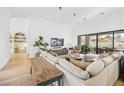 Bright living room featuring hardwood floors, and sliding glass doors that lead to the backyard pool at 10969 Tranquil Waters Ct, Las Vegas, NV 89135