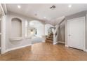 Bright foyer showcasing arched entryways, decorative columns, stairs, and tile flooring at 10993 Ladyburn Ct, Las Vegas, NV 89141