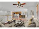 Bright, virtually staged living room with plush seating, and an open concept to the kitchen at 11247 Villa Trentino Ct, Las Vegas, NV 89141