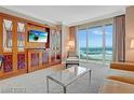 Cozy living room with elegant furnishings, built in entertainment center, and a stunning view of the water at 125 E Harmon Ave # 2814/2816, Las Vegas, NV 89109