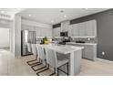 Modern kitchen with gray cabinetry, a stainless steel refrigerator, and a large island with seating at 147 Harmonica Ave # Lot 24, Henderson, NV 89015