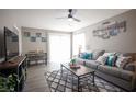 Comfortable living room with plush gray couch, contemporary decor, and natural light at 1511 Living Desert Dr # C, Las Vegas, NV 89119
