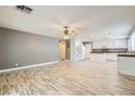 Spacious living area seamlessly connects to the kitchen with wood flooring at 1733 Gentle Brook St, North Las Vegas, NV 89084