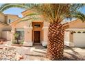 Welcoming single-story home with a well-manicured desert landscape and inviting entryway at 1742 Sand Storm Dr, Henderson, NV 89074