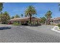 Community entrance featuring a covered parking area and lush landscaping at 2050 W Warm Springs Rd # 2822, Henderson, NV 89014