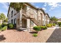 Exterior of the home featuring an outdoor staircase leading to upper units and landscaped grounds at 2305 W Horizon Ridge Pkwy # 3713, Henderson, NV 89052