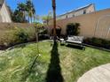 A cozy backyard space featuring green grass, comfortable seating, and a peaceful atmosphere at 2559 Purple Heather Pl, Henderson, NV 89052