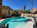 Relaxing backyard pool with a spa, surrounded by lush greenery and a private setting at 2559 Purple Heather Pl, Henderson, NV 89052