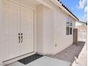 Inviting double door entrance to a home with neutral paint and desert landscaping at 3032 Hartley Cove Ave, North Las Vegas, NV 89081