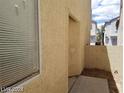 Exterior home view showcasing stucco siding and small backyard block wall at 3123 Inlet Bay Ave, North Las Vegas, NV 89031