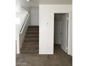 Carpeted staircase in a neutrally painted home with white trim and door at 3123 Inlet Bay Ave, North Las Vegas, NV 89031