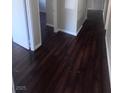 Hallway with rich brown hardwood floors and neutral wall paint at 3151 Soaring Gulls Dr # 1092, Las Vegas, NV 89128
