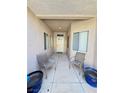Inviting entryway with seating area leading to front door with chairs and covered porch at 3263 Quail Song Dr, Laughlin, NV 89029