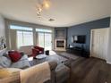 Cozy living room with fireplace, comfortable seating, and a view of the outdoor pool area at 3263 Quail Song Dr, Laughlin, NV 89029