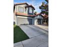Inviting home with a two-car garage, complemented by a well-manicured lawn at 3704 Blairmoor St, North Las Vegas, NV 89032