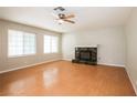 Bright living room featuring hardwood floors, a ceiling fan, and a cozy fireplace at 3751 Crellin Cir, Las Vegas, NV 89120