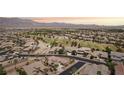 Panoramic aerial view of the community showcasing lush green spaces, well-maintained homes and mountain views at 3904 Redbreast Ln, North Las Vegas, NV 89084