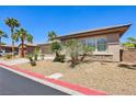 Well-kept front yard with desert landscaping, palm trees, and attractive curb appeal in a quiet neighborhood at 3904 Redbreast Ln, North Las Vegas, NV 89084