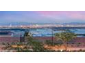 Backyard view of Las Vegas skyline, showcasing twinkling city lights and mountain backdrop at 484 Windstone Crest Ave, Las Vegas, NV 89138