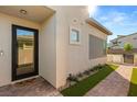 Inviting front entrance with a glass door, brick walkway, and manicured landscaping at 484 Windstone Crest Ave, Las Vegas, NV 89138