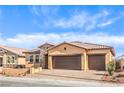 Single-story home with three-car garage, stone accents, neutral stucco and a well-maintained desert landscaped front yard at 522 Copper Falcon Ave, Henderson, NV 89011