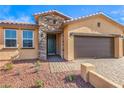 Close-up of a home's facade showing the stone accents, olive front door, and three-car garage at 522 Copper Falcon Ave, Henderson, NV 89011