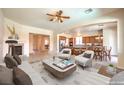Spacious living room open to the kitchen featuring a fireplace and modern décor at 5260 Acqua Ln, Pahrump, NV 89061