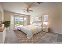 Bright main bedroom with a king bed, sliding glass doors to the backyard, and neutral decor at 5260 Acqua Ln, Pahrump, NV 89061