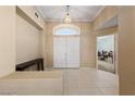 Bright foyer featuring tile flooring, a decorative light fixture, and a view of the interior at 5310 Eel River Ct, North Las Vegas, NV 89031