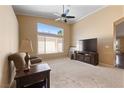 Bright living room featuring carpet floors, a large window and ceiling fan at 5310 Eel River Ct, North Las Vegas, NV 89031