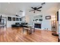 Open-concept living room with hardwood floors and cozy fireplace at 590 Tam O Shanter, Las Vegas, NV 89109