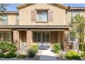 Charming two-story home features desert landscaping, a walkway, and a cozy bench by the front door at 6247 Milford Sound St, Las Vegas, NV 89148